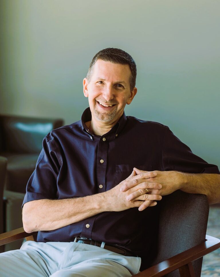 Mike Panfil, bookkeeper, casual in armchair